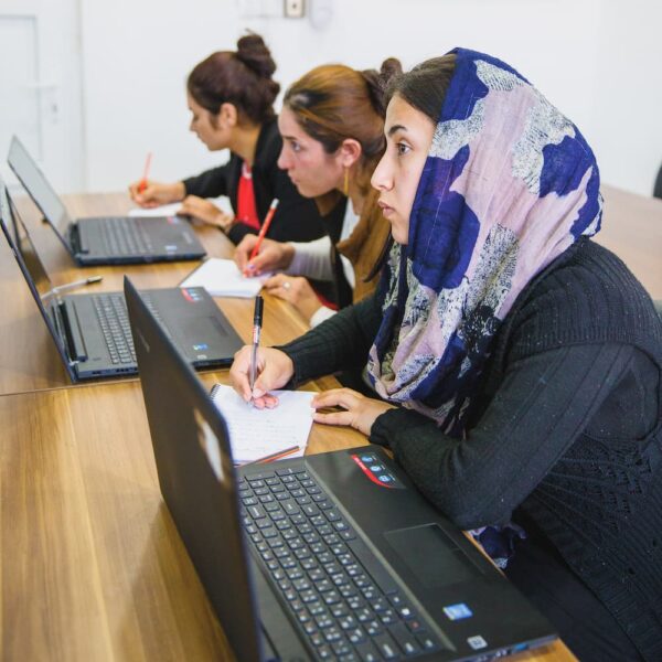 women learning with laptops